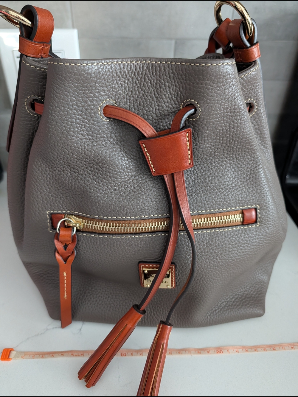 Dooney & Bourke Taupe Pebbled Leather Drawstring Bucket Bag with Brown Trim